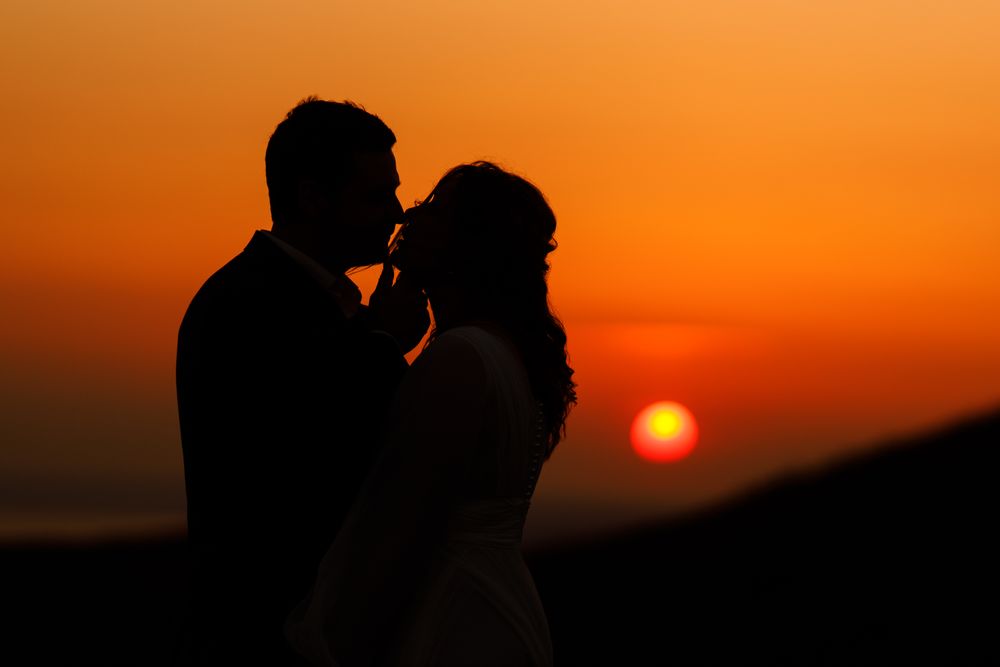 Bride And Groom Kissing In Love Sunset