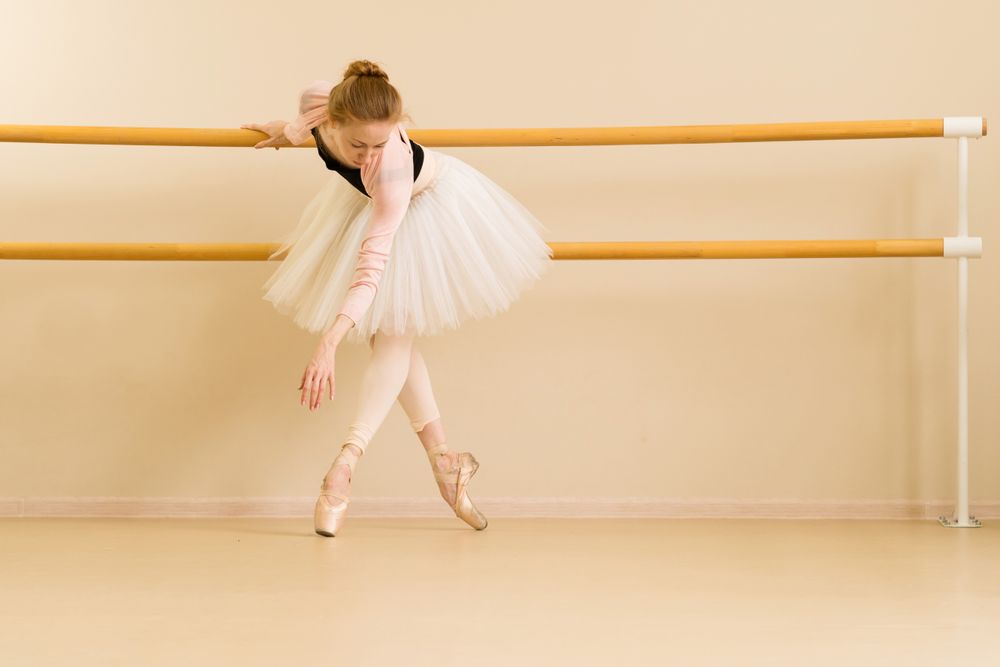 A ballet dancer balances on pointe