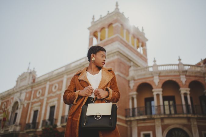Stylish Black woman with handbag on street