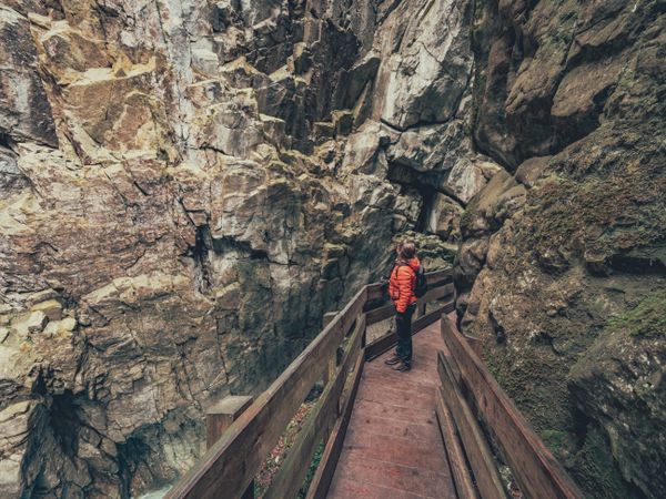 Traveller admiring picturesque view of mountain ridge