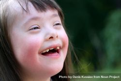Girl with Down syndrome smiling outside 56R1Y5
