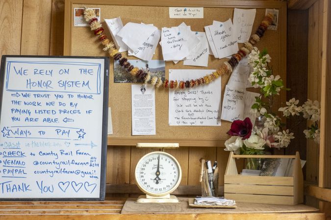Desk at shop with cork board covered with notes