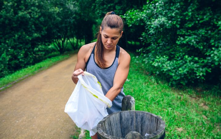 Woman throwing garbage after plogging