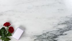 Happy Valentine’s Day with pink giftbox on marble stone background