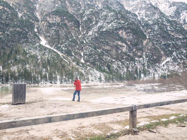 Man standing and taking photo of rocky landscape