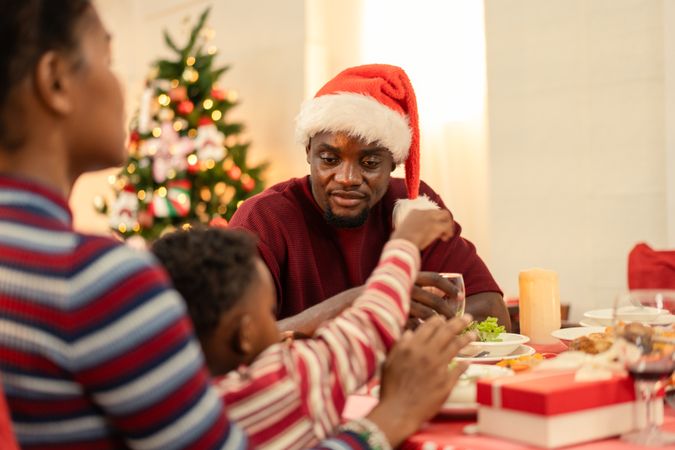 Black family celebrating Christmas dinner table