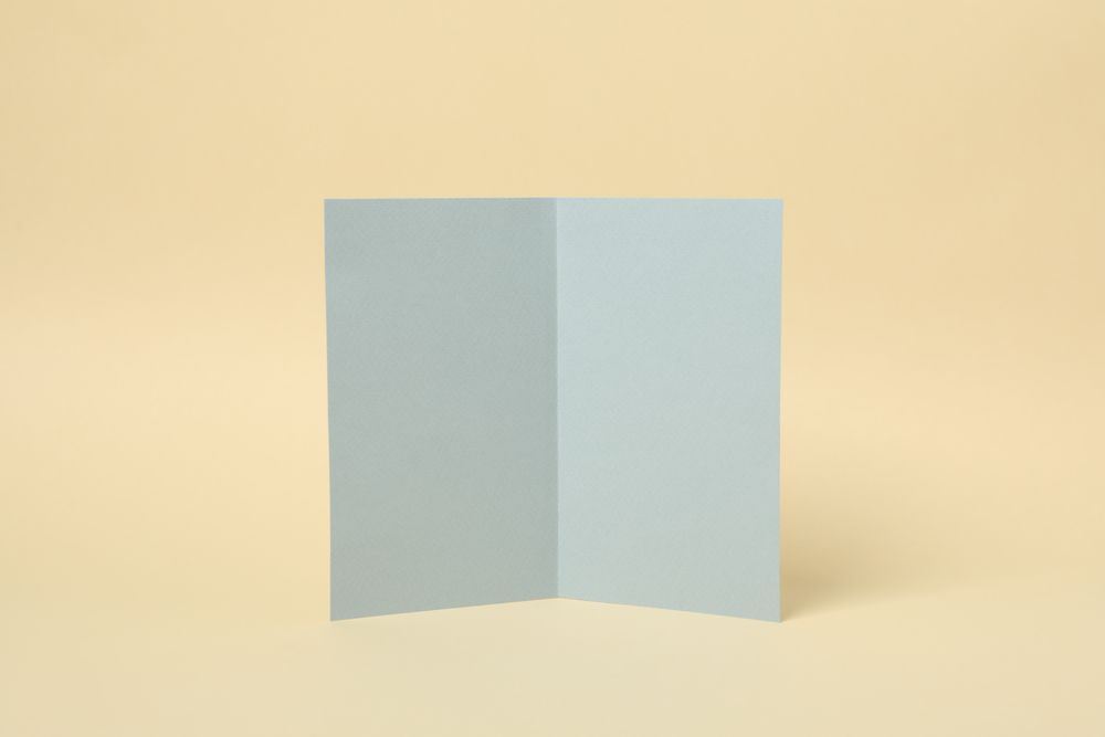 Light gray cardboard on beige background, space for text