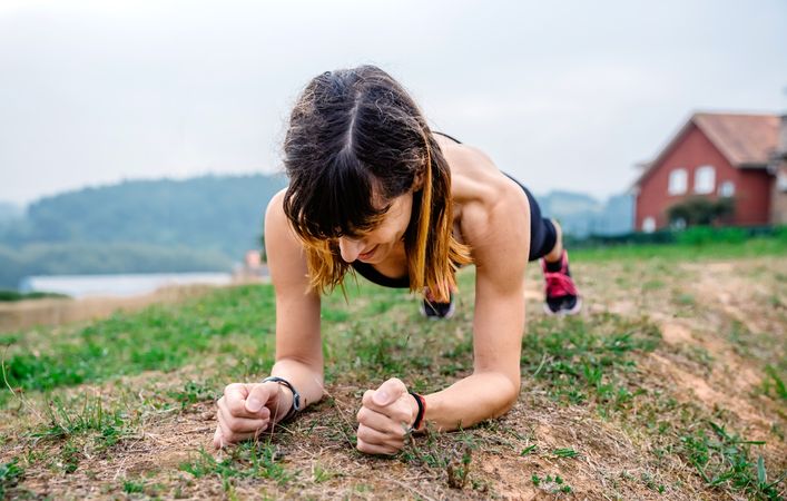 Female athlete training doing plank