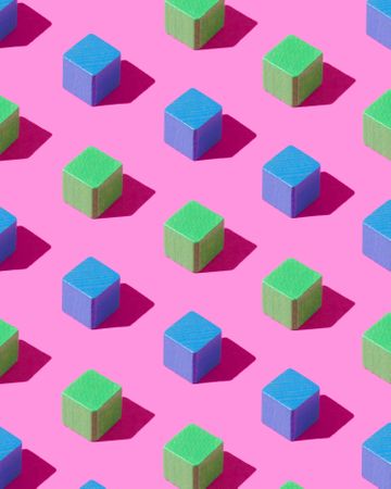 Blue and green cubes on pink background