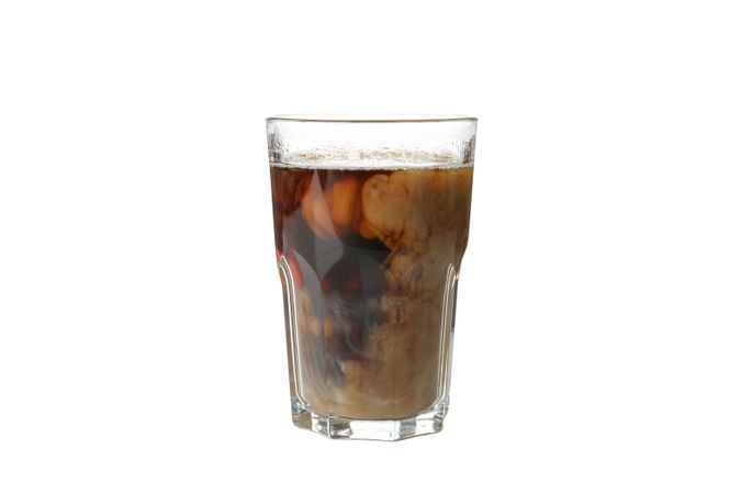 Glass of ice coffee isolated on plain background