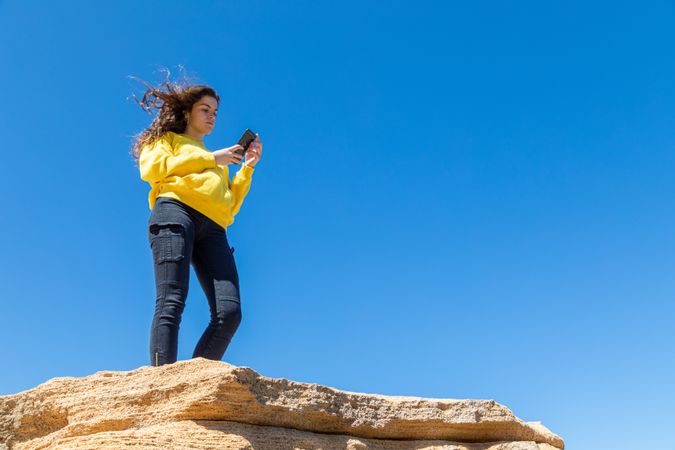 female taking photo of rocky landscape