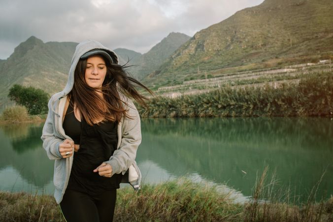 Positive woman running in park