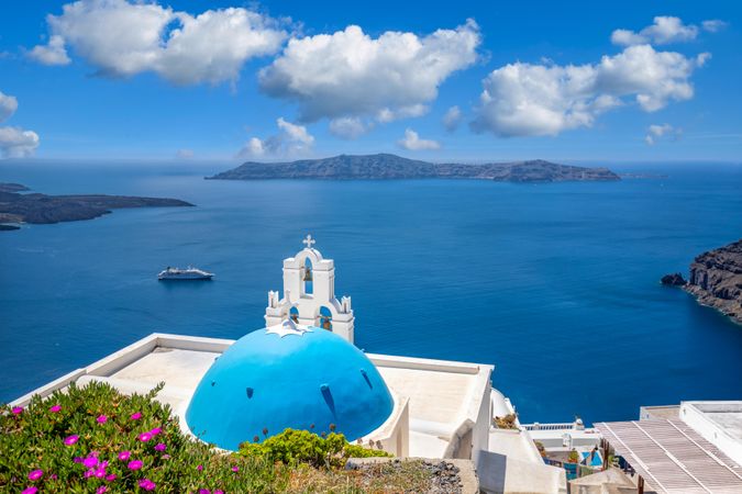 Dome of Orthodox Church in Santorini with view of sea