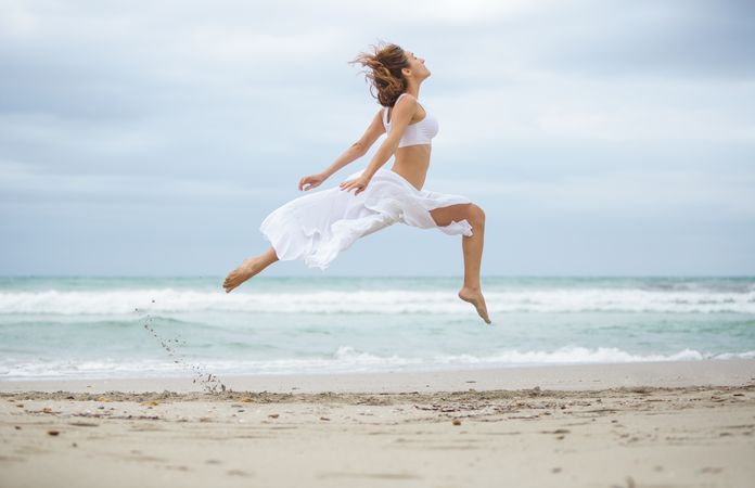 woman dancing near sea