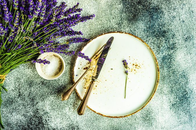 Top view of table setting on marble counter with bunch of lavender