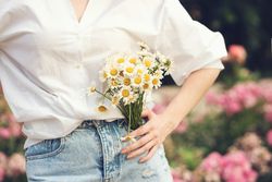 Woman with a bouquet of chrysanthemums. Background flowers