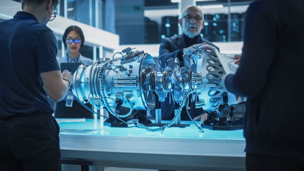 Team of Engineers, Project Manager and Machinery Operators Collaborate on a New Type of a Turbine Engine