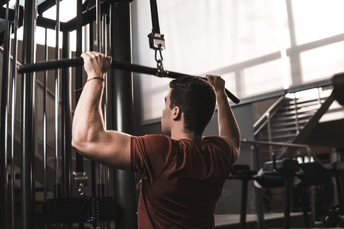 Young fitness man training in gym