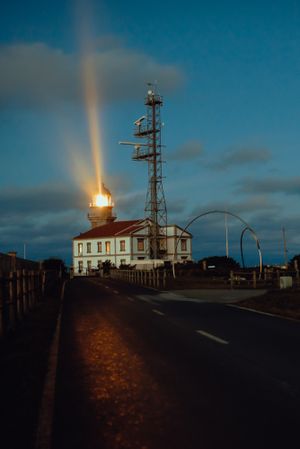 Road and lighthouse in evening