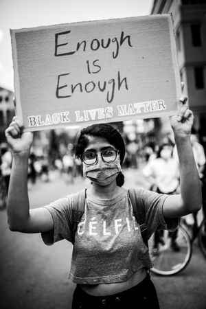 MONTREAL, QUEBEC, CANADA – June 7 2020- Woman holding a sign above her head at a BLM rally
