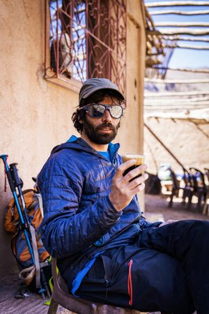 Bearded tourist resting at street cafe