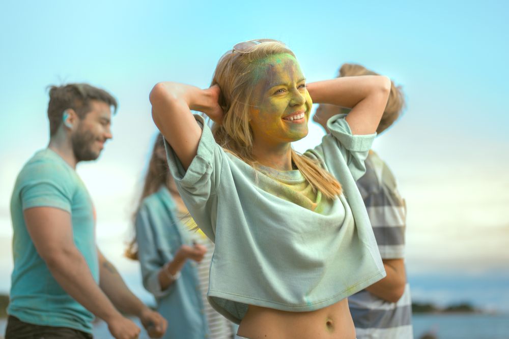 Portrait of a Woman Dances in Celebration of Holi Festival With Her Friends.