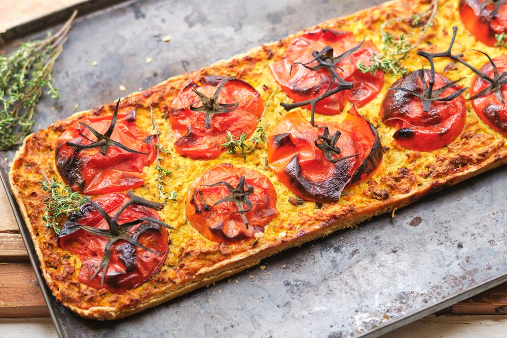 Delicious flatbread with tomato slices and thyme sprigs
