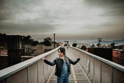 Stylish girl on walkway in city
