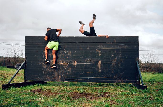 Participants in obstacle course climbing wall