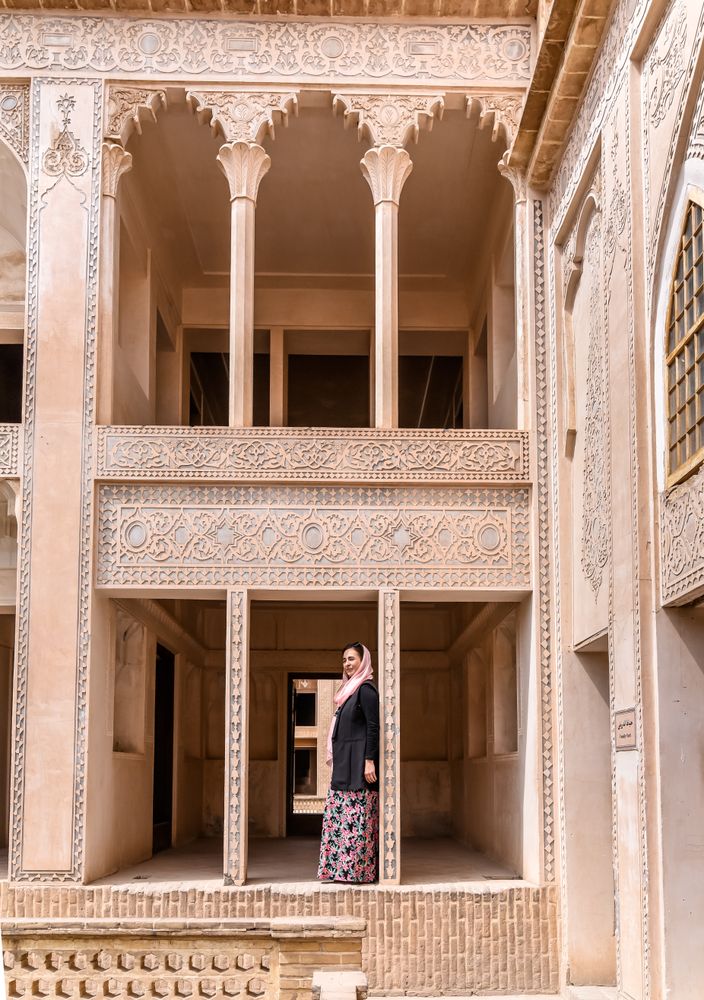 Woman standing on terrace of traditional oriental mosque