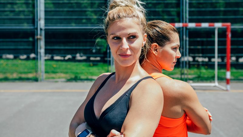 Sportswomen posing with crossed arms