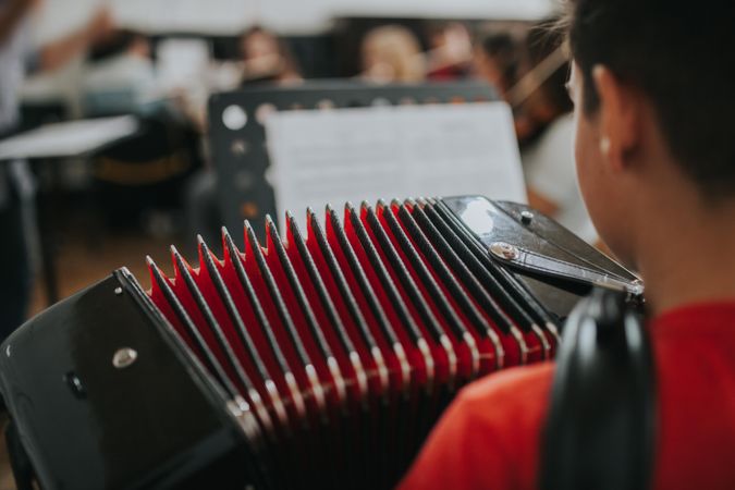 Rear view of student playing the accordion instrument