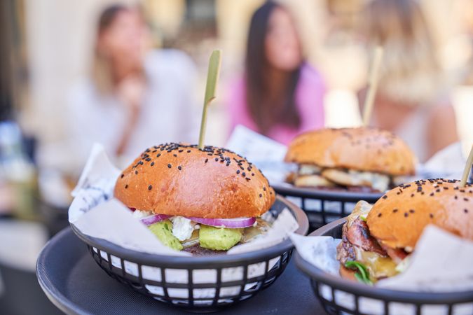 Appetizing burgers on skewers in street cafe