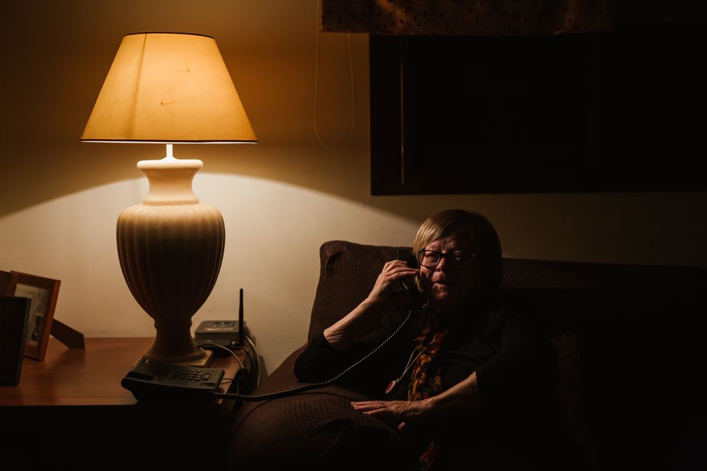Pleased older female talking on phone