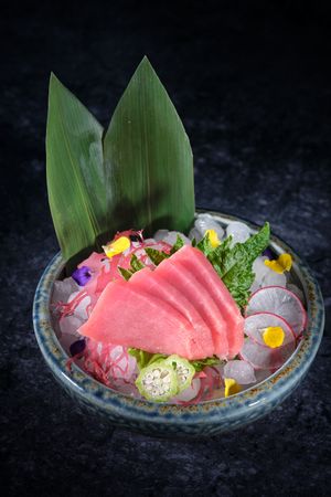 Ceramic plate with raw fish and vegetables