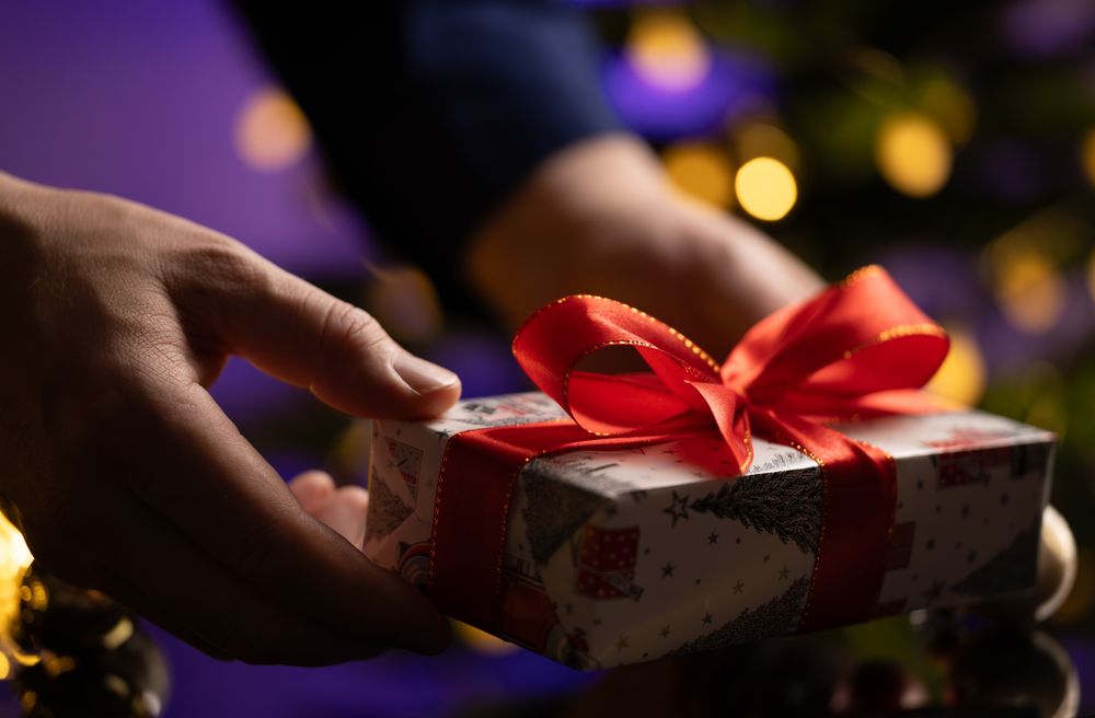 Man Giving Gift Christmas Tree