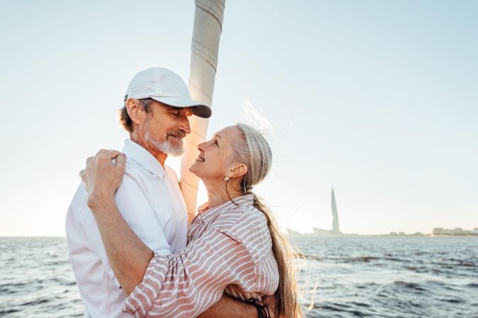 Mature couple enjoying sunset on a boat