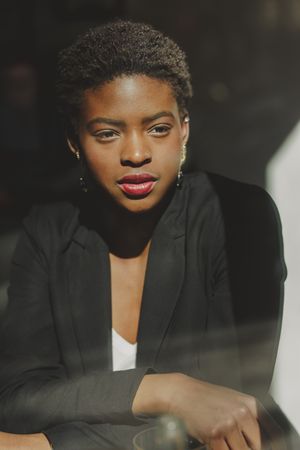 Smiling stylish Black woman in cafe