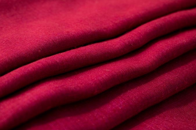Close up Red fabric folded background texture.