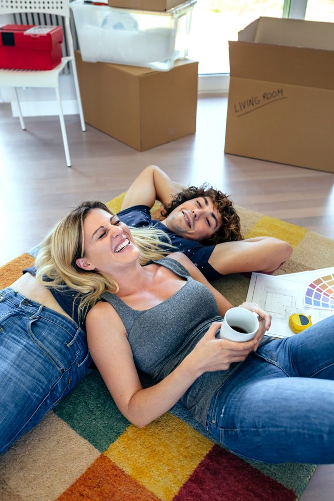 Couple resting lying on the carpet