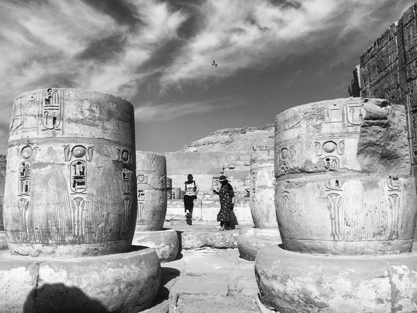Grayscale photo of two women at the archeological site in Luxor,Luxor Governorate,Egypt