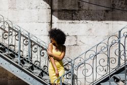 Stylish female leaning on railing outdoors