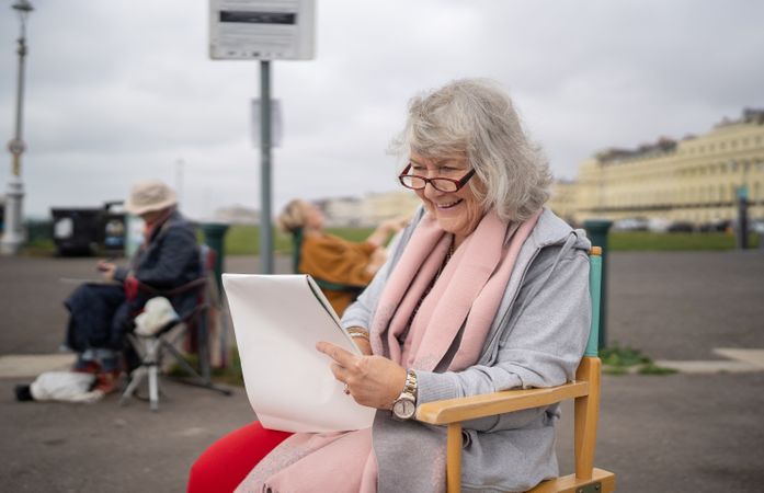 Smiling woman outside drawing