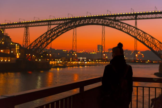 Female walking on embankment during sundown