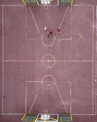 Aerial view of people playing in basketball court 0VJkv0