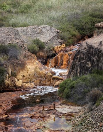 Small red river waterfall in Riotinto, Huelva