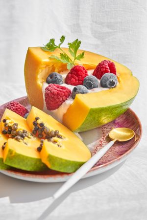 Plate with papaya bowl and berries