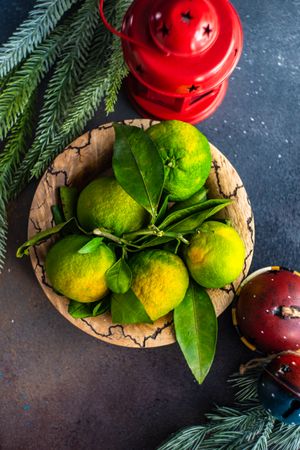 Top view of fresh green tangerines in bowl with lantern