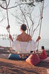 Young woman sitting on swing