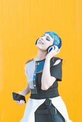 Futuristic woman using smartphone and listening to music